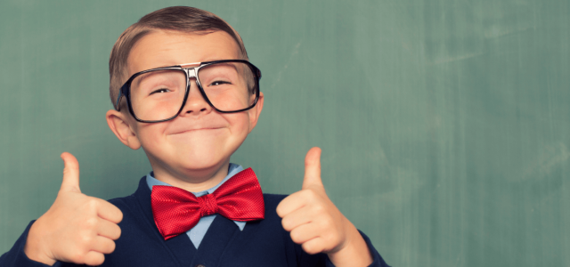 Close up portrait of child giving two thumbs up